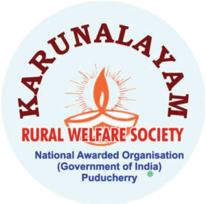 Logo for KARUNALAYAM RURAL WELFARE SOCIETY, featuring a traditional Indian earthen lamp (diya) with a flame, and the location Puducherry.