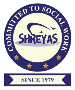 Logo for Shreyas, a circular seal with the text "Committed to Social Work" and "Since 1979."